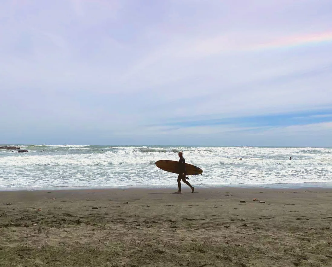 surfer sunset beach port waikato